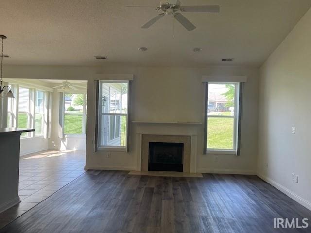 3239 S Parnel Ct, Bloomington, IN 47403 - unfurnished living room with ceiling fan, plenty of natural light, and a fireplace with flush hearth