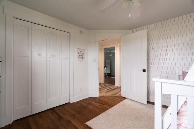 5157 N County Rd 850 W, Mulberry, IN 46058 - unfurnished bedroom with dark wood-style flooring, a closet, ceiling fan, and wallpapered walls