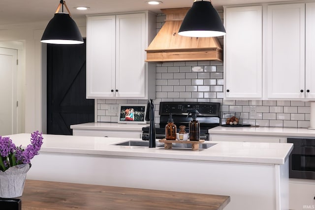 5157 N County Rd 850 W, Mulberry, IN 46058 - kitchen with premium range hood, light countertops, decorative backsplash, range, and white cabinets