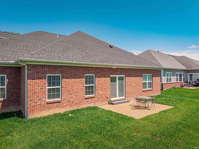 4261 Martha Ct, Newburgh, IN 47630 - back of property with a shingled roof, a lawn, brick siding, and a patio area