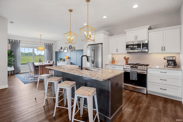 4831 Leeward Ln, Lafayette, IN 47909 - kitchen with stainless steel appliances, dark wood-style flooring, backsplash, white cabinetry, and recessed lighting