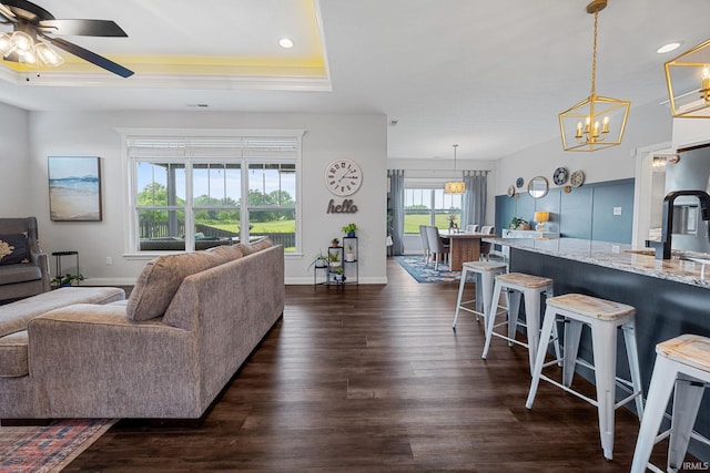 4831 Leeward Ln, Lafayette, IN 47909 - living area featuring dark wood-style floors, ceiling fan, a raised ceiling, recessed lighting, and a chandelier