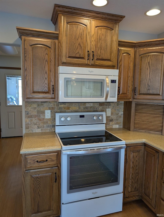 1260 Carrington Way, Berne, IN 46711 - kitchen featuring white appliances, tasteful backsplash, light wood-style flooring, and brown cabinetry