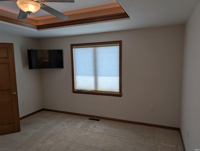 1260 Carrington Way, Berne, IN 46711 - empty room featuring light colored carpet, a raised ceiling, and a ceiling fan