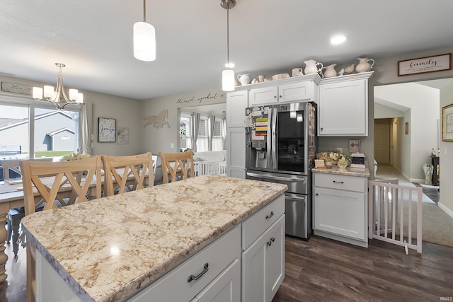 773 Sycamore St, Decatur, IN 46733 - kitchen featuring stainless steel fridge, a chandelier, white cabinets, dark wood finished floors, and pendant lighting