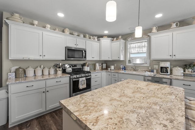 773 Sycamore St, Decatur, IN 46733 - kitchen with stainless steel appliances, white cabinetry, pendant lighting, a center island, and recessed lighting