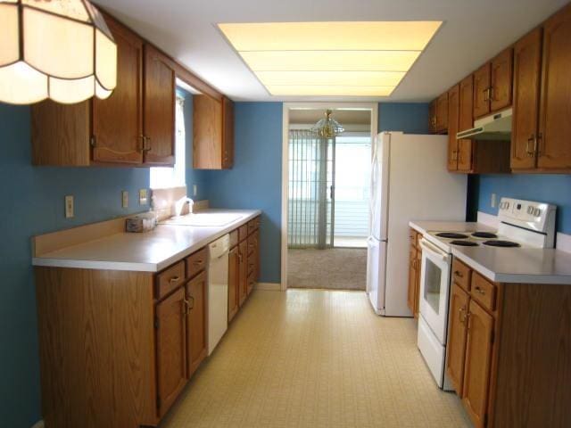 52289 Wembley Dr, South Bend, IN 46637 - kitchen featuring white appliances, under cabinet range hood, brown cabinets, and light countertops