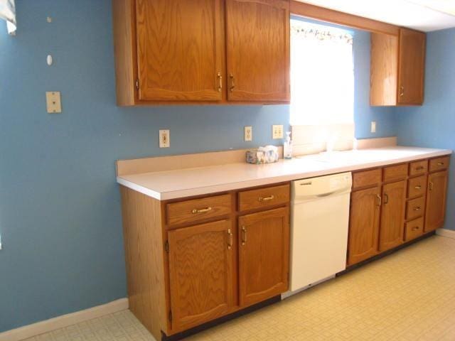 52289 Wembley Dr, South Bend, IN 46637 - kitchen with dishwasher, brown cabinets, light countertops, and light floors