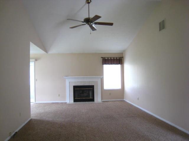 52289 Wembley Dr, South Bend, IN 46637 - unfurnished living room featuring lofted ceiling, a ceiling fan, carpet flooring, and a fireplace with flush hearth