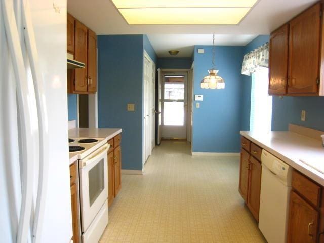 52289 Wembley Dr, South Bend, IN 46637 - kitchen featuring white appliances, light countertops, under cabinet range hood, and plenty of natural light