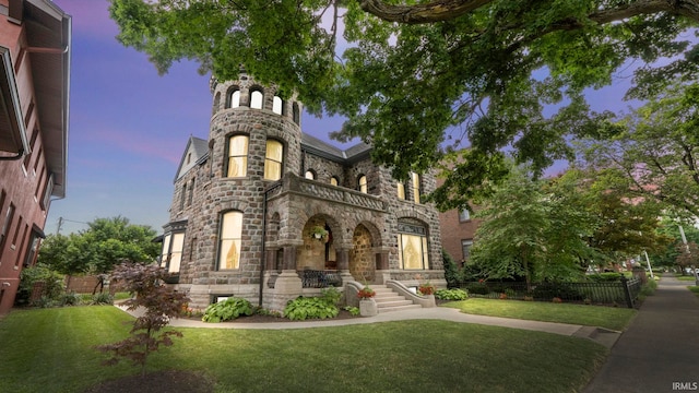 721 W Wayne St, Fort Wayne, IN 46802 - view of front of house featuring stone siding, a yard, and a balcony