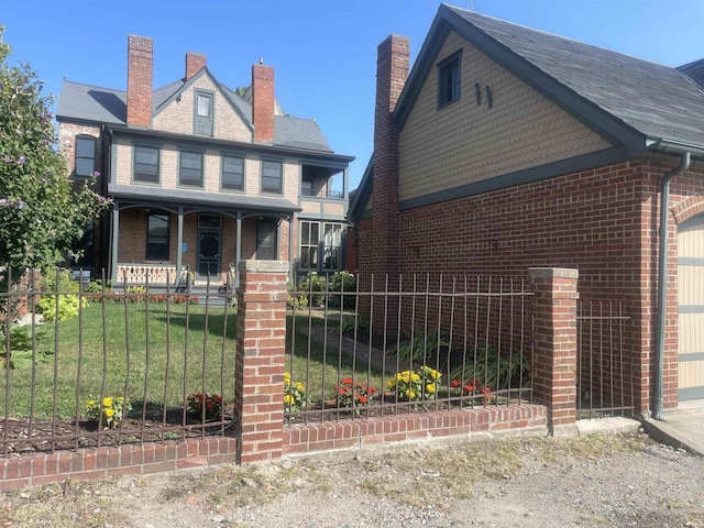 721 W Wayne St, Fort Wayne, IN 46802 - view of front of property with covered porch, a fenced front yard, brick siding, and a chimney