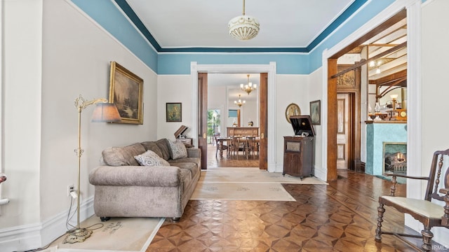 721 W Wayne St, Fort Wayne, IN 46802 - living room with a chandelier, a lit fireplace, and crown molding