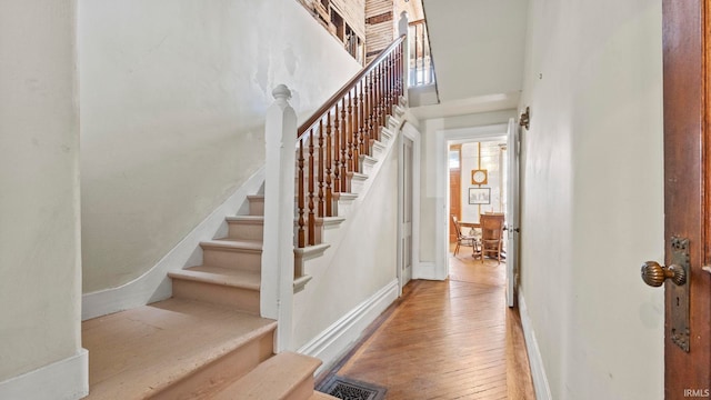 721 W Wayne St, Fort Wayne, IN 46802 - staircase with wood-type flooring and a high ceiling
