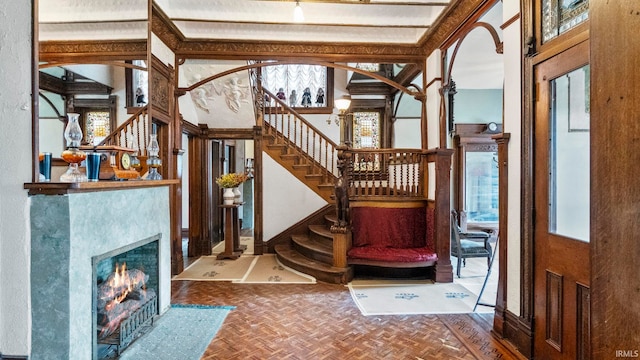721 W Wayne St, Fort Wayne, IN 46802 - foyer entrance with stairs, plenty of natural light, arched walkways, and a fireplace with flush hearth