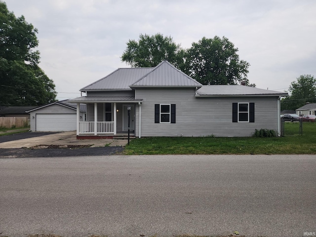 1584 Snyder St, Wabash, IN 46992 - view of front facade featuring a porch, a metal roof, an outdoor structure, and a garage