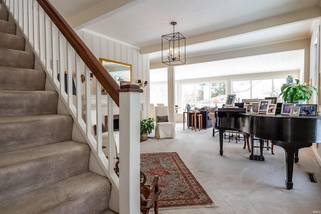 921 S Sheridan Dr, Bloomington, IN 47401 - stairs with carpet, a chandelier, and ornamental molding