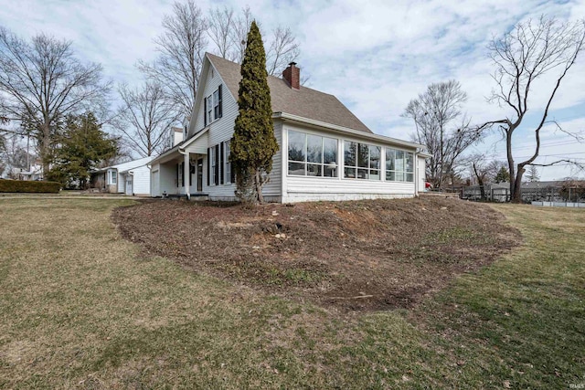 921 S Sheridan Dr, Bloomington, IN 47401 - view of side of property featuring a chimney, a lawn, a sunroom, and a shingled roof