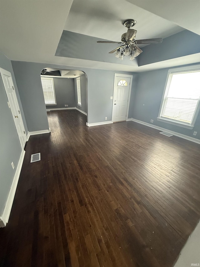 923 W Jackson St, Kokomo, IN 46901 - unfurnished living room featuring arched walkways, ceiling fan, and dark wood finished floors
