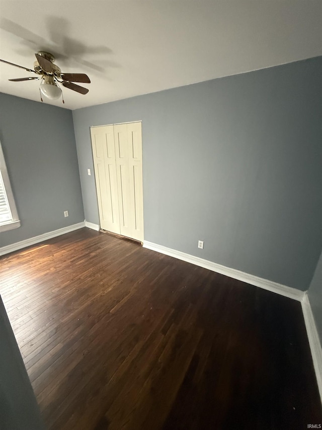 923 W Jackson St, Kokomo, IN 46901 - unfurnished bedroom featuring dark wood-style flooring, a closet, and ceiling fan