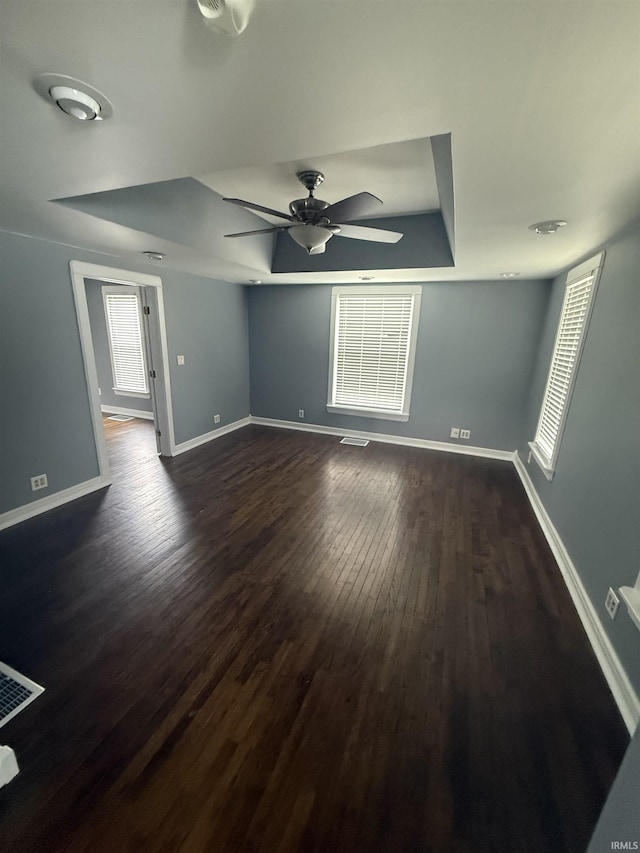 923 W Jackson St, Kokomo, IN 46901 - unfurnished room featuring ceiling fan, dark wood-type flooring, and a tray ceiling