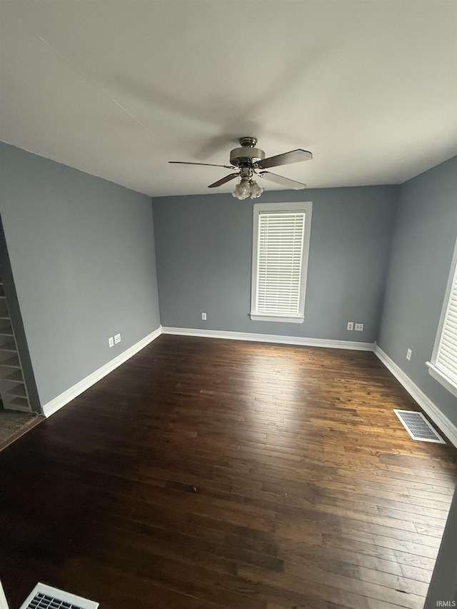 923 W Jackson St, Kokomo, IN 46901 - spare room featuring dark wood-type flooring, a ceiling fan, and plenty of natural light