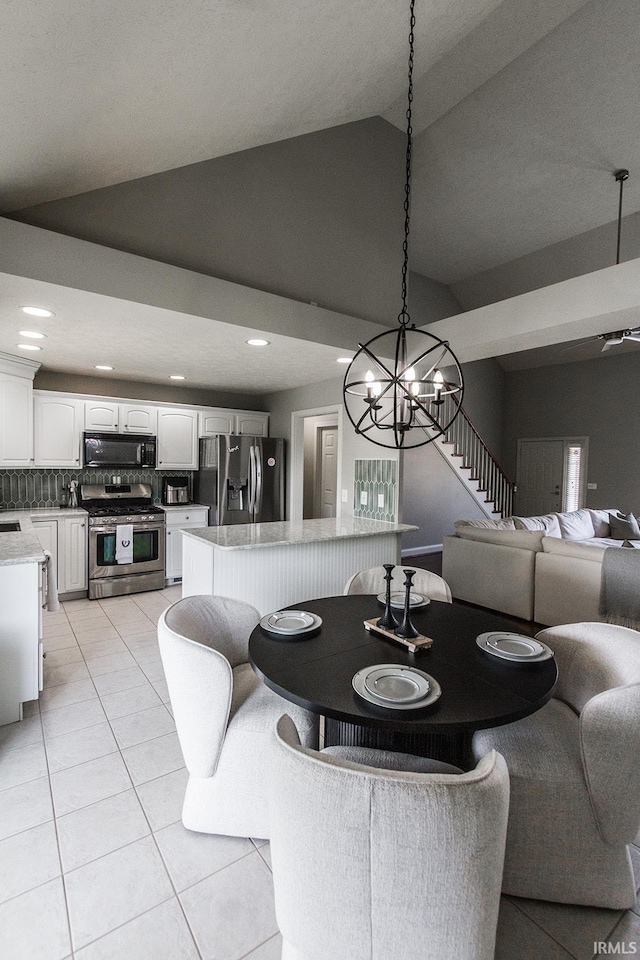 2123 Bunker Ln, Evansville, IN 47725 - dining area featuring light tile patterned flooring, recessed lighting, a chandelier, and high vaulted ceiling