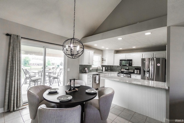 2123 Bunker Ln, Evansville, IN 47725 - dining area with light tile patterned floors, lofted ceiling, a chandelier, and recessed lighting