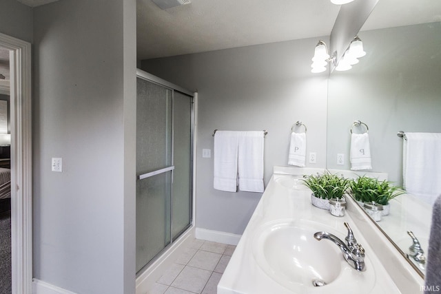 2123 Bunker Ln, Evansville, IN 47725 - bathroom with a stall shower, tile patterned floors, double vanity, and connected bathroom