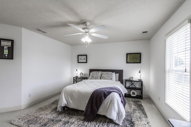 2123 Bunker Ln, Evansville, IN 47725 - bedroom with light carpet, ceiling fan, and a textured ceiling