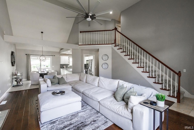 2123 Bunker Ln, Evansville, IN 47725 - living area featuring ceiling fan, stairs, dark wood-style floors, a chandelier, and high vaulted ceiling