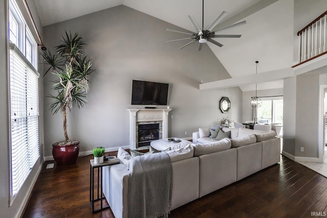 2123 Bunker Ln, Evansville, IN 47725 - living area with high vaulted ceiling, a ceiling fan, a fireplace, wood finished floors, and a chandelier