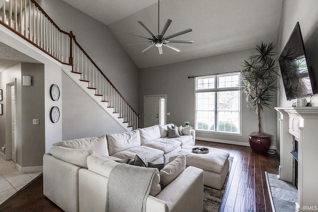 2123 Bunker Ln, Evansville, IN 47725 - living room featuring a ceiling fan, high vaulted ceiling, hardwood / wood-style floors, a fireplace, and stairway