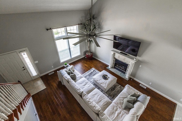 2123 Bunker Ln, Evansville, IN 47725 - living room featuring a ceiling fan, high vaulted ceiling, hardwood / wood-style floors, and a fireplace with flush hearth
