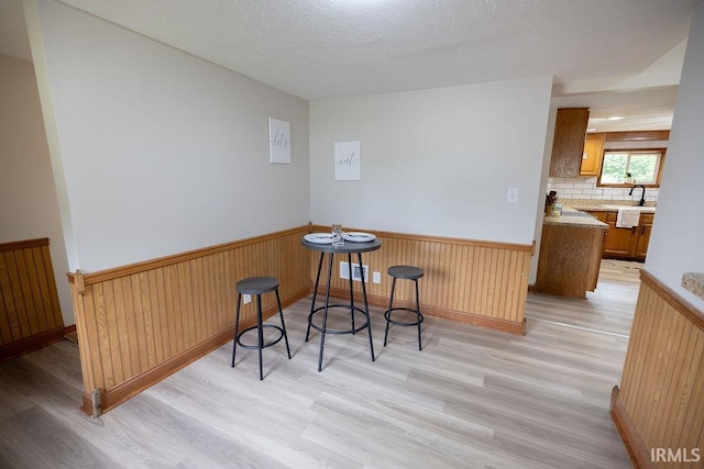 3529 S Walnut St, Muncie, IN 47304 - living area with light wood finished floors, wainscoting, and wood walls
