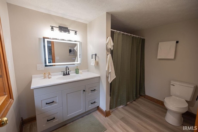 3529 S Walnut St, Muncie, IN 47304 - full bath with a textured ceiling, wood finished floors, vanity, and a shower with curtain