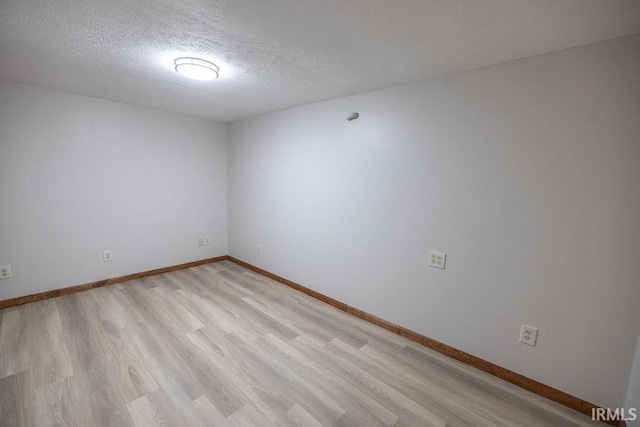 3529 S Walnut St, Muncie, IN 47304 - unfurnished room with light wood-type flooring and a textured ceiling