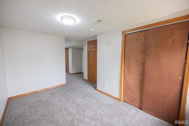 3529 S Walnut St, Muncie, IN 47304 - unfurnished bedroom with light carpet, a textured ceiling, and a closet