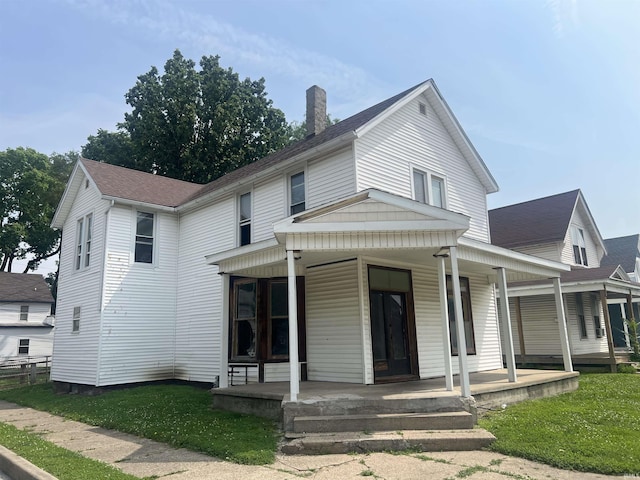 1200 Hartford St, Lafayette, IN 47904 - view of front of property with a chimney, covered porch, a front lawn, and roof with shingles