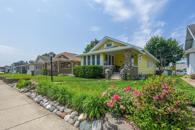 425 Gernhart Ave, Mishawaka, IN 46544 - bungalow-style house with covered porch, a chimney, a residential view, and a front lawn