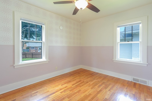 425 Gernhart Ave, Mishawaka, IN 46544 - unfurnished room featuring light wood finished floors, plenty of natural light, a ceiling fan, and wallpapered walls