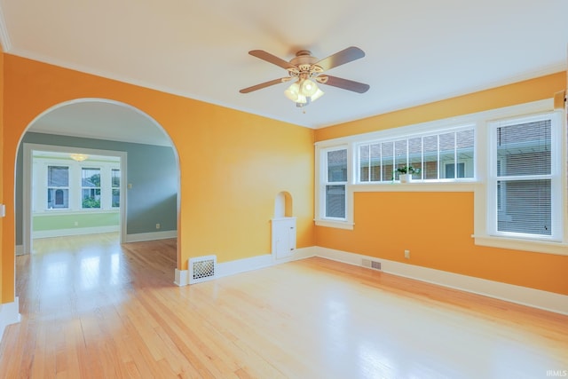 425 Gernhart Ave, Mishawaka, IN 46544 - empty room with wood finished floors, arched walkways, ceiling fan, and crown molding