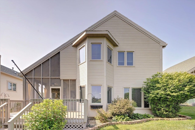 9109 S Front Nine Dr, Bloomington, IN 47401 - rear view of house featuring a sunroom and a wooden deck