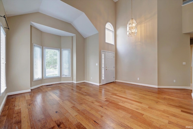 9109 S Front Nine Dr, Bloomington, IN 47401 - entryway featuring light wood-type flooring, a chandelier, and high vaulted ceiling