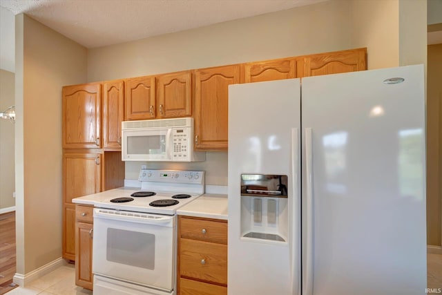 9109 S Front Nine Dr, Bloomington, IN 47401 - kitchen featuring white appliances, light countertops, and light tile patterned flooring