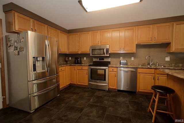 327 Hillside Ave, Roanoke, IN 46783 - kitchen with stainless steel appliances, light stone countertops, tasteful backsplash, and light brown cabinets