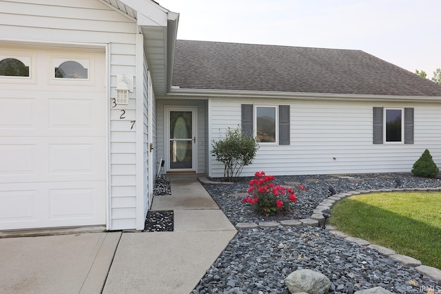 327 Hillside Ave, Roanoke, IN 46783 - property entrance featuring a garage and a shingled roof