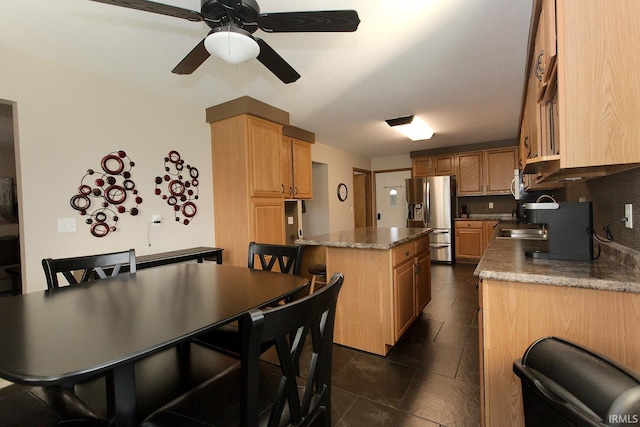 327 Hillside Ave, Roanoke, IN 46783 - kitchen featuring stainless steel fridge, ceiling fan, a center island, and dark tile patterned flooring