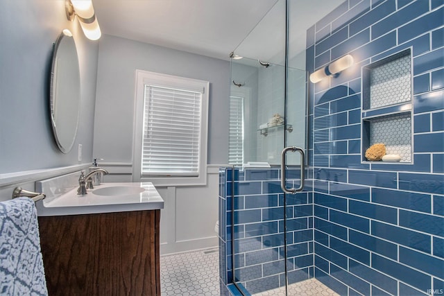 1730 Oak Park Dr, South Bend, IN 46617 - full bathroom with vanity, tile patterned floors, a stall shower, wainscoting, and a decorative wall