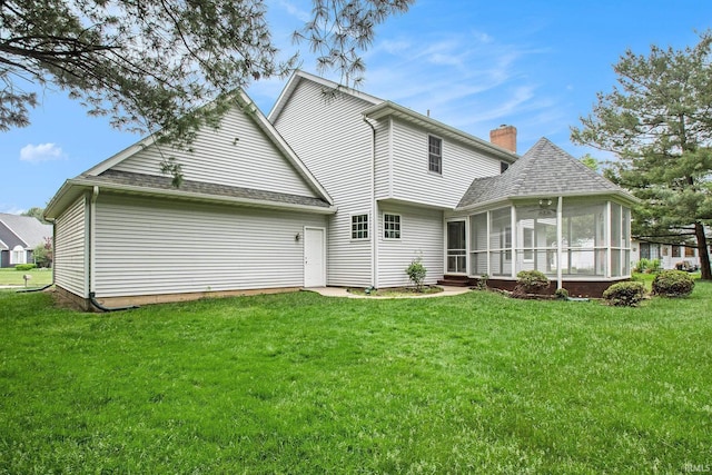52206 Filbert Rd, Granger, IN 46530 - back of property with a sunroom, a yard, and a chimney